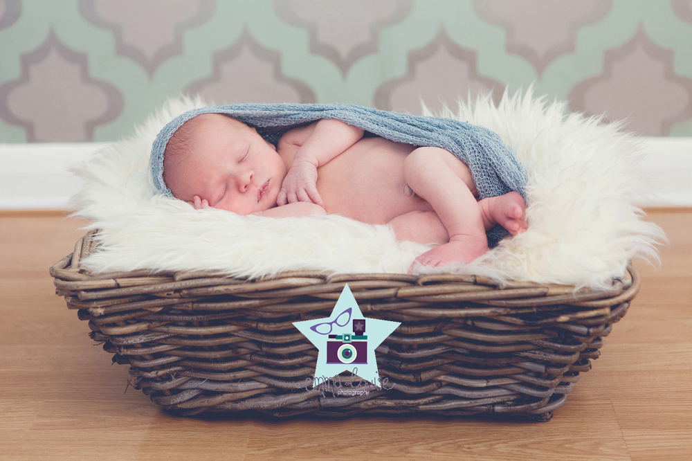 newborn photography of baby posed safely in basket