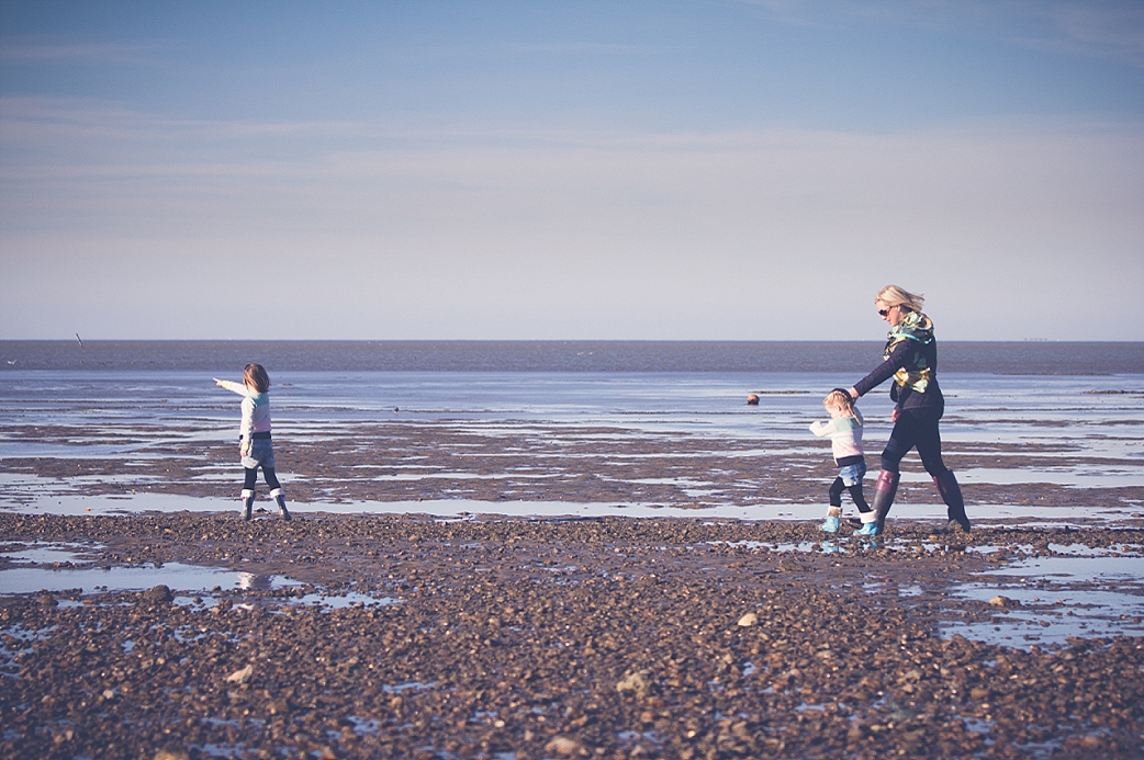 Walking across the beach at Seasalter - Family Photography Kent